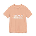 Front view of peach Suckers and Losers t-shirt with white protest text honoring fallen soldiers by Peach2Impeach