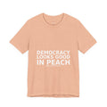 Folded peach Democracy Looks Good in Peach pro democracy political t-shirt by Peach2Impeach