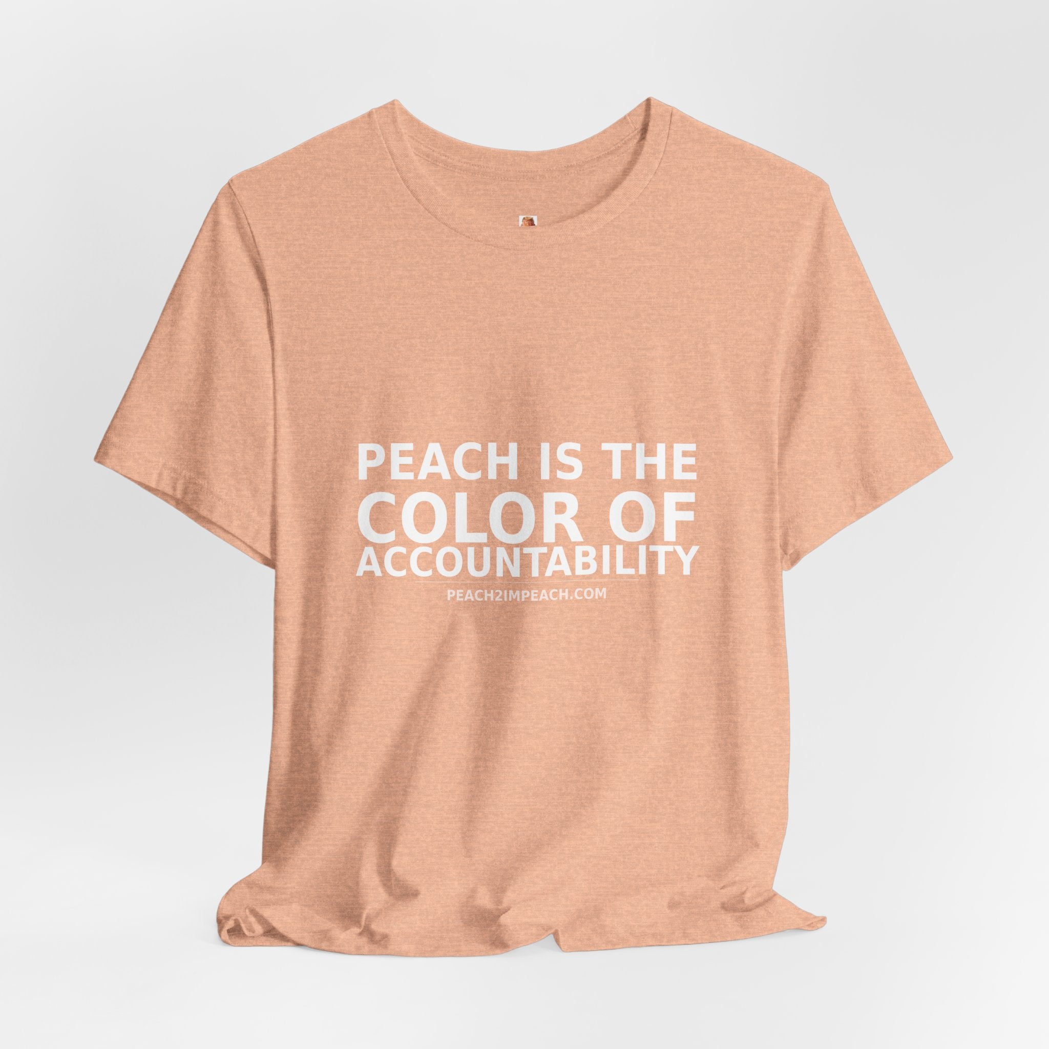 Angled lifestyle view of peach The Color of Accountability political statement t-shirt by Peach2Impeach