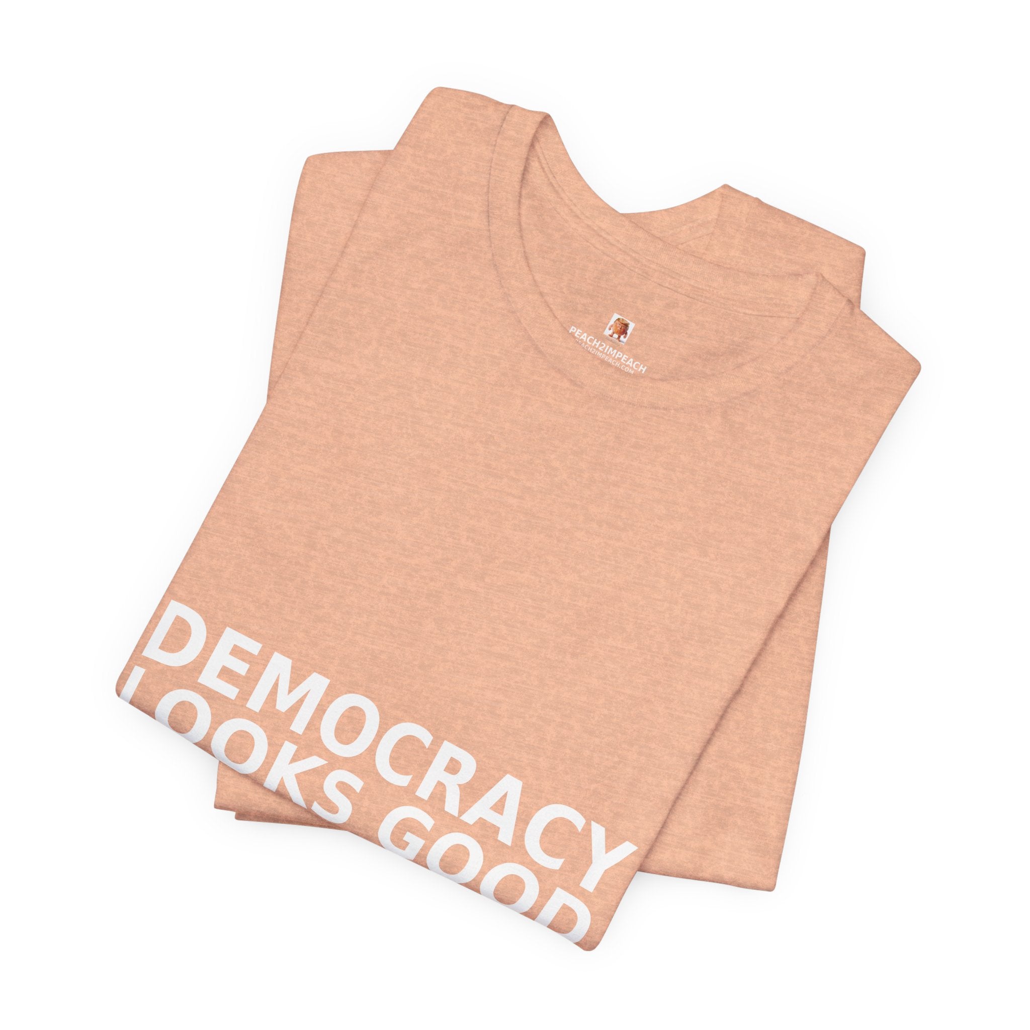 Angled lifestyle view of peach Democracy Looks Good in Peach pro democracy political t-shirt by Peach2Impeach